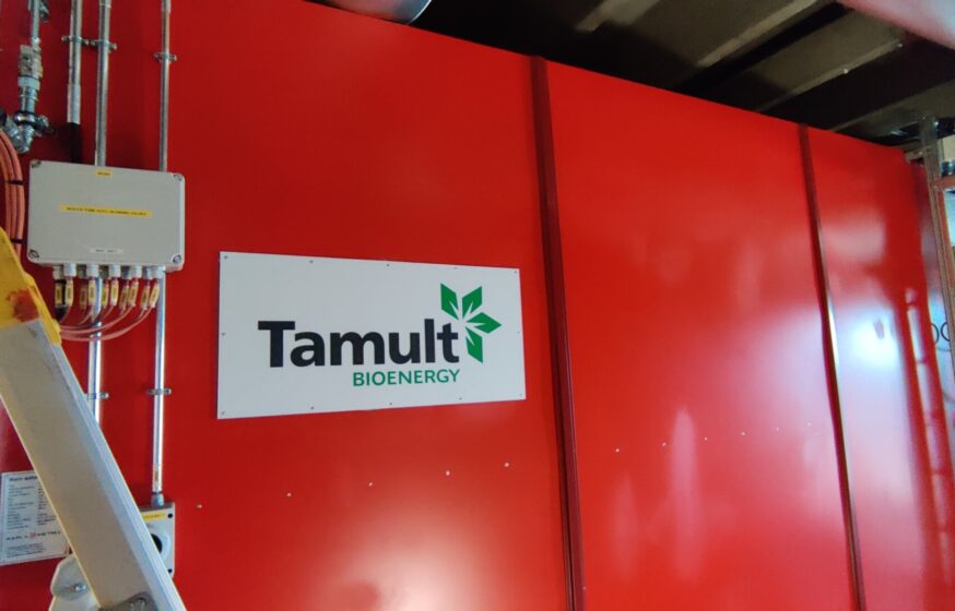 Biomass boiler house with Tamult logo